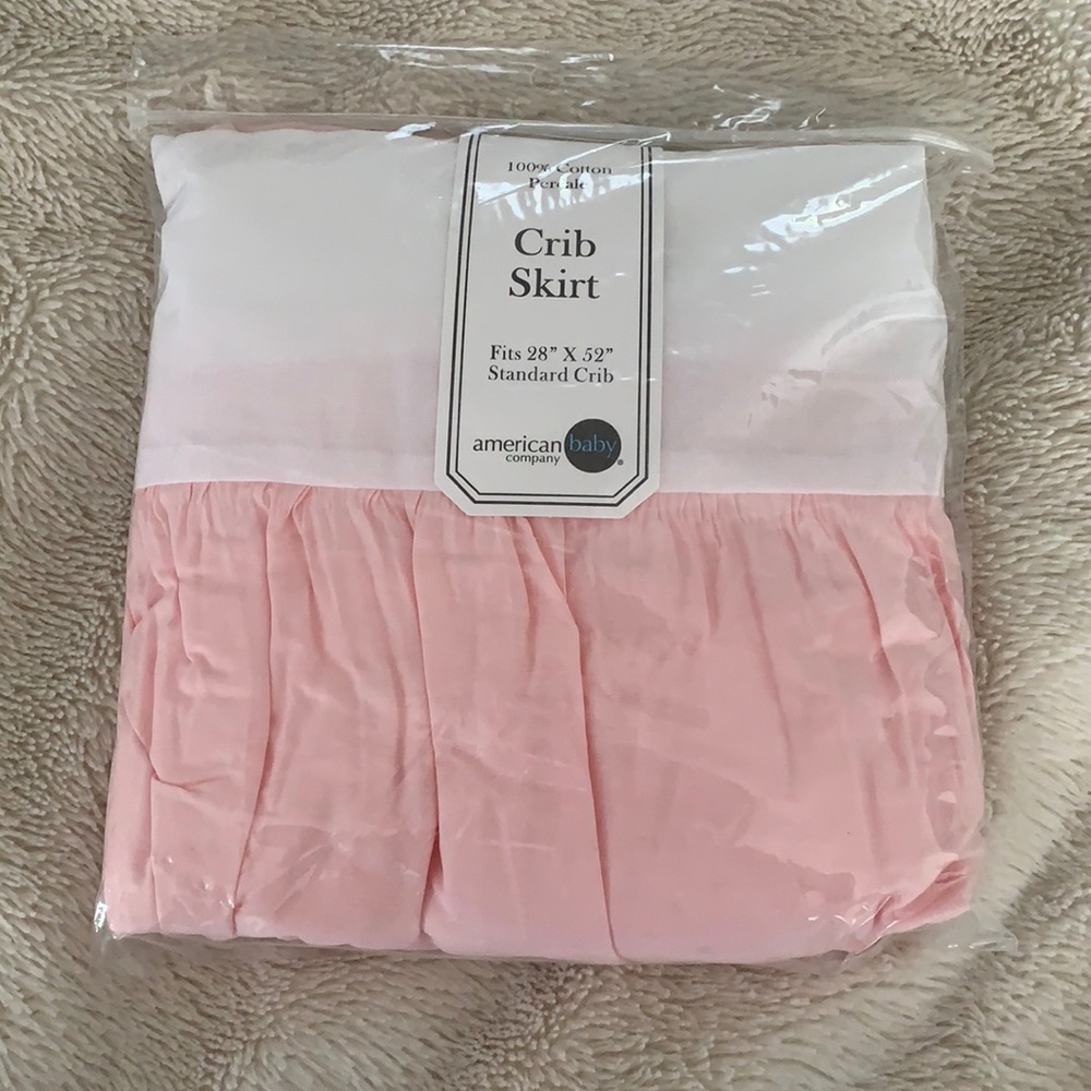 Pink and white crib skirt